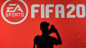 A visitor takes a picture at the booth of the "FIFA 20" football game at the Gamescom video games trade fair in Cologne, western Germany, on August 20, 2019. (Photo by Ina FASSBENDER / AFP) (Photo credit should read INA FASSBENDER/AFP/Getty Images)