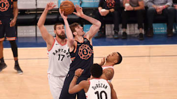 NEW YORK, NY - MARCH 11: Luke Kornet #2 of the New York Knicks lays up a shot against CJ Miles #0 of the Toronto Raptors during the game at Madison Square Garden on March 11, 2018 in New York City, New York. NOTE TO USER: User expressly acknowledges and agrees that, by downloading and or using this photograph, User is consenting to the terms and conditions of the Getty Images License Agreement. (Photo by Matteo Marchi/Getty Images)