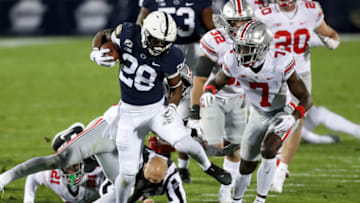 Oct 31, 2020; University Park, Pennsylvania, USA; Penn State Nittany Lions running back Devyn Ford (28) runs with the ball during the first quarter against the Ohio State Buckeyes as an official falls down at Beaver Stadium. Mandatory Credit: Matthew OHaren-USA TODAY Sports