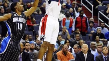 Dec 2, 2013; Washington, DC, USA; Washington Wizards small forward Trevor Ariza (1) attempts a shot as Orlando Magic point guard Ronnie Price (10) defends during the first half at the Verizon Center. Mandatory Credit: Brad Mills-USA TODAY Sports
