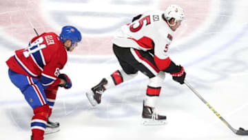 Dec 12, 2015; Montreal, Quebec, CAN; Ottawa Senators defenseman Cody Ceci (5) plays the puck against Montreal Canadiens center Lars Eller (81) during the third period at Bell Centre. Mandatory Credit: Jean-Yves Ahern-USA TODAY Sports