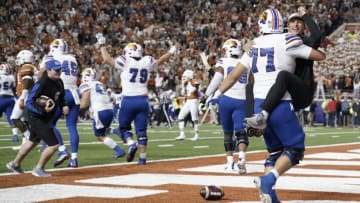 Nov 13, 2021; Austin, Texas, USA; Kansas Jayhawks players celebrate after a game winning two point conversion in overtime against the Texas Longhorns at Darrell K Royal-Texas Memorial Stadium. Mandatory Credit: Scott Wachter-USA TODAY Sports