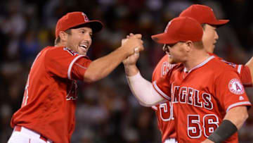 Apr 23, 2016; Anaheim, CA, USA; Los Angeles Angels relief pitcher Huston Street (16) high-fives teammate Kole Calhoun (56) after defeating the Seattle Mariners 4-2 at Angel Stadium of Anaheim. Mandatory Credit: Robert Hanashiro-USA TODAY Sports