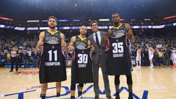 OAKLAND, CA - FEBRUARY 12: Klay Thompson #11, Stephen Curry #30 and Kevin Durant #35 of the Golden State Warriors pose for a photo with Bob Meyers holding up their Charlotte All-Star jersey's before the game against the Utah Jazz on February 12, 2019 at ORACLE Arena in Oakland, California. NOTE TO USER: User expressly acknowledges and agrees that, by downloading and or using this photograph, user is consenting to the terms and conditions of Getty Images License Agreement. Mandatory Copyright Notice: Copyright 2019 NBAE (Photo by Noah Graham/NBAE via Getty Images)