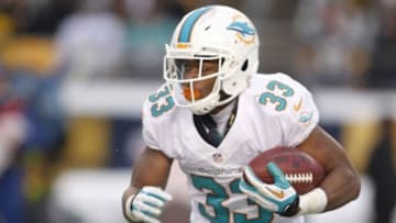 Dec 8, 2013; Pittsburgh, PA, USA; Miami Dolphins running back Daniel Thomas (33) rushes the ball against the Pittsburgh Steelers during the fourth quarter at Heinz Field. The Miami Dolphins won 34-28. Mandatory Credit: Charles LeClaire-USA TODAY Sports