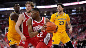during the Ohio State Buckeyes guard Malaki Branham (22) drives past Michigan Wolverines forward Brandon Johns Jr. (23) half of the NCAA men's basketball game at Value City Arena in Columbus on March 6, 2022. Michigan won 75-69.Michigan Wolverines At Ohio State Buckeyes