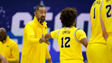 INDIANAPOLIS, INDIANA - MARCH 22: Head coach Juwan Howard of the Michigan Wolverines celebrates with Mike Smith #12 against the LSU Tigers in the second round game of the 2021 NCAA Men's Basketball Tournament at Lucas Oil Stadium on March 22, 2021 in Indianapolis, Indiana. (Photo by Jamie Squire/Getty Images)