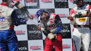 LONG BEACH, CA - APRIL 21: (L-R) Justin Wilson of England driver of the #19 Dale Coyne Racing Dallara Honda, third place, Takuma Sato of Japan driver of the #14 ABC Supply A. J. Foyt Racing Dallara Honda, winner, Graham Rahal driver of the #15 Midas Big O Tires Dallara Honda second place celebrate by spraying champagne the IndyCar Series Toyota Grand Prix of Long Beach on April 21, 2013 on the streets of Long Beach, California. (Photo by Robert Laberge/Getty Images)