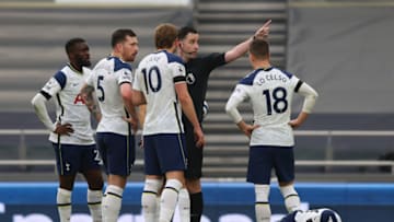 LONDON, ENGLAND - APRIL 11: Tanguy Ndombele, Pierre-Emile Hojbjerg, Harry Kane, and Giovani Lo Celso of Tottenham Hotspur confront referee Chris Kavanagh, as Son Heung-Min of Tottenham Hotspur lies on the ground injured, after being fouled in the build up to a goal by Manchester United, which is later disallowed due to the foul, following a VAR review during the Premier League match between Tottenham Hotspur and Manchester United at Tottenham Hotspur Stadium on April 11, 2021 in London, England. Sporting stadiums around the UK remain under strict restrictions due to the Coronavirus Pandemic as Government social distancing laws prohibit fans inside venues resulting in games being played behind closed doors. (Photo by Marc Atkins/Getty Images)
