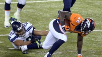 Feb 2, 2014; East Rutherford, NJ, USA; Denver Broncos running back Montee Ball (28) runs the ball against Seattle Seahawks outside linebacker K.J. Wright (50) during the second half in Super Bowl XLVIII at MetLife Stadium. Mandatory Credit: Kirby Lee-USA TODAY Sports