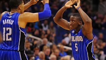 Mar 28, 2014; Orlando, FL, USA; Orlando Magic guard Victor Oladipo (5) and forward Tobias Harris (12) celebrate after Harris drew a foul in overtime as the Magic beat the Charlotte Bobcats 110-105 at Amway Center. Mandatory Credit: David Manning-USA TODAY Sports