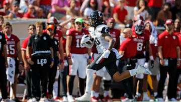 Cincinnati Bearcats linebacker Deshawn Pace runs back an interception against the Indiana Hoosiers. The Enquirer.