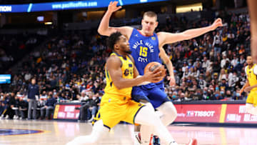 DENVER, CO - JANUARY 05: Donovan Mitchell #45 of the Utah Jazz goes to the basket against Nikola Jokic #15 of the Denver Nuggets during the fourth quarter at Ball Arena on January 5, 2022 in Denver, Colorado. NOTE TO USER: User expressly acknowledges and agrees that, by downloading and or using this photograph, User is consenting to the terms and conditions of the Getty Images License Agreement. (Photo by C. Morgan Engel/Getty Images)