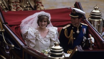 LONDON, ENGLAND - JULY 29: Prince Charles, Prince of Wales and Diana, Princess of Wales, wearing a wedding dress designed by David and Elizabeth Emanuel and the Spencer family Tiara, ride in an open carriage, from St. Paul's Cathedral to Buckingham Palace, following their wedding on July 29, 1981 in London, England. (Photo by Anwar Hussein/Getty Images)