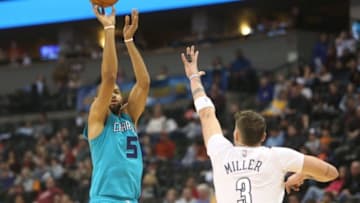Jan 10, 2016; Denver, CO, USA; Charlotte Hornets guard Nicolas Batum (5) shoots the ball over Denver Nuggets guard Mike Miller (3) during the second half at Pepsi Center. The Nuggets won 95-92. Mandatory Credit: Chris Humphreys-USA TODAY Sports