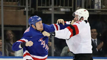 NEW YORK, NEW YORK - SEPTEMBER 24: Cody McLeod #8 of the New York Rangers fights against Eric Gryba #2 of the New Jersey Devils at Madison Square Garden on September 24, 2018 in New York City. The Rangers defeated the Devils 4-3 in overtime. (Photo by Bruce Bennett/Getty Images)