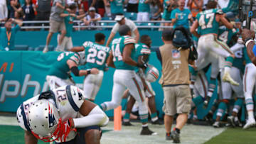 MIAMI GARDENS, FL - DECEMBER 9: New England Patriots' J.C. Jackson is despondent as the Dolphins Kenyan Drake is mobbed in the back of the end zone by teammates after he scored the game-winning touchdown on the last play of the game. Miami stunned New England 34-33. The New England Patriots visit the Miami Dolphins in a regular season NFL football game at Hard Rock Stadium in Miami Gardens, FL on Dec. 9, 2018. (Photo by Jim Davis/The Boston Globe via Getty Images)