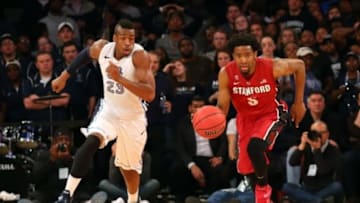Mar 31, 2015; New York, NY, USA; Stanford Cardinal guard Chasson Randle (5) grabs a loose ball as Old Dominion Monarchs forward Richard Ross (23) follows during the second half in the semifinals of the 2015 NIT college basketball tournament at Madison Square Garden. Stanford Cardinal won 67-60. Mandatory Credit: Anthony Gruppuso-USA TODAY Sports