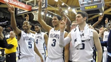 Feb 16, 2015; Villanova, PA, USA; Villanova Wildcats guard Phil Booth (5), guard Josh Hart (3) and guard Ryan Arcidiacono (15) hold up the