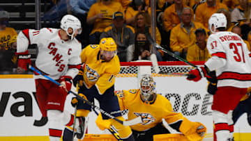 NASHVILLE, TENNESSEE - MAY 27: Jordan Staal #11 of the Carolina Hurricanes deflects a shot on goalie Juuse Saros #74 of the Nashville Predators during the third period in Game Six of the First Round of the 2021 Stanley Cup Playoffs at Bridgestone Arena on May 27, 2021 in Nashville, Tennessee. (Photo by Frederick Breedon/Getty Images)