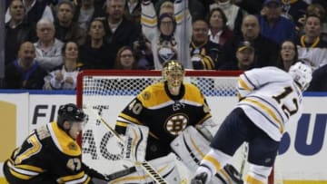 Feb 4, 2016; Buffalo, NY, USA; Boston Bruins goalie Tuukka Rask (40) makes a save on Buffalo Sabres right wing Brian Gionta (12) as defenseman Torey Krug (47) defends during the first period at First Niagara Center. Mandatory Credit: Kevin Hoffman-USA TODAY Sports