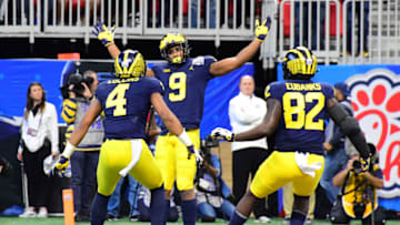 ATLANTA, GEORGIA - DECEMBER 29: Donovan Peoples-Jones #9 of the Michigan Wolverines is congratulated by his teammates Nico Collins #4 and Nick Eubanks #82 after scoring a first quarter touchdown reception against the Florida Gators during the Chick-fil-A Peach Bowl at Mercedes-Benz Stadium on December 29, 2018 in Atlanta, Georgia. (Photo by Scott Cunningham/Getty Images)