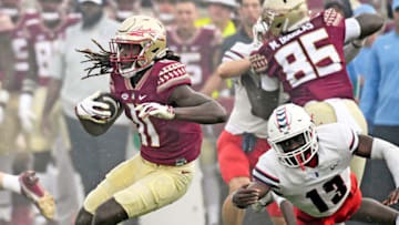 Aug 27, 2022; Tallahassee, Florida, USA; Florida State Seminoles wide receiver Sam McCall (11) runs the ball against Duquesne Dukes defensive back CJ Barnes (13) during the first half at Doak S. Campbell Stadium. Mandatory Credit: Melina Myers-USA TODAY Sports