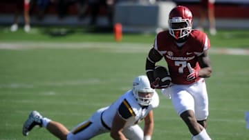 Sep 12, 2015; Little Rock, AR, USA; Arkansas Razorbacks wide receiver Damon Mitchell (7) runs the ball after a catch against Toledo Rockets defensive end John Stepec (10) during the second quarter at War Memorial Stadium. Mandatory Credit: Mark D. Smith-USA TODAY Sports