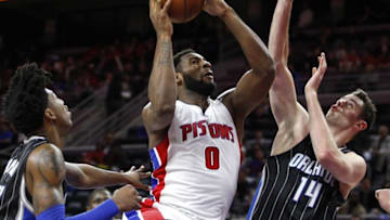 Mar 23, 2016; Auburn Hills, MI, USA; Detroit Pistons center Andre Drummond (0) grabs the loose ball in front of Orlando Magic guard Elfrid Payton (L) and forward Jason Smith (14) during the fourth quarter at The Palace of Auburn Hills. The Pistons won 118-102. Mandatory Credit: Raj Mehta-USA TODAY Sports