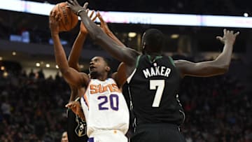 MILWAUKEE, WISCONSIN - NOVEMBER 23: Josh Jackson #20 of the Phoenix Suns drives between Giannis Antetokounmpo #34 and Thon Maker #7 of the Milwaukee Bucks during the second half of a game at Fiserv Forum on November 23, 2018 in Milwaukee, Wisconsin. NOTE TO USER: User expressly acknowledges and agrees that, by downloading and or using this photograph, User is consenting to the terms and conditions of the Getty Images License Agreement. (Photo by Stacy Revere/Getty Images)
