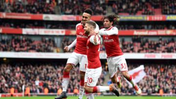 LONDON, ENGLAND - MARCH 11: Shkodran Mustafi of Arsenal celebrates coring the first goal with Pierre-Emerick Aubameyang of Arsenal and Mohamed Elneny of Arsenal during the Premier League match between Arsenal and Watford at Emirates Stadium on March 11, 2018 in London, England. (Photo by Michael Regan/Getty Images)