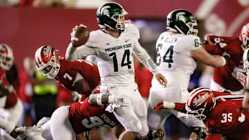 BLOOMINGTON, IN - SEPTEMBER 22: Brian Lewerke #14 of the Michigan State Spartans looks to throw the ball under pressure from Charles Campbell #93 and Nile Sykes #35 of the Indiana Hoosiers at Memorial Stadium on September 22, 2018 in Bloomington, Indiana. (Photo by Michael Hickey/Getty Images)