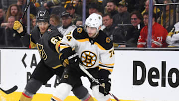 Feb 20, 2019; Las Vegas, NV, USA; Boston Bruins left wing Jake DeBrusk (74) looks to pass the puck away from Vegas Golden Knights left wing Max Pacioretty (67) during the third period at T-Mobile Arena. Mandatory Credit: Stephen R. Sylvanie-USA TODAY Sports