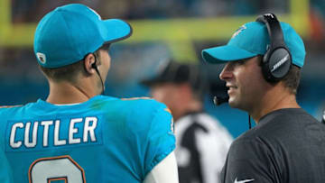MIAMI GARDENS, FL - AUGUST 17: Jay Cutler #6 of the Miami Dolphins talks with head coach Adam Gase during a preseason game against the Baltimore Ravens at Hard Rock Stadium on August 17, 2017 in Miami Gardens, Florida. (Photo by Mike Ehrmann/Getty Images)