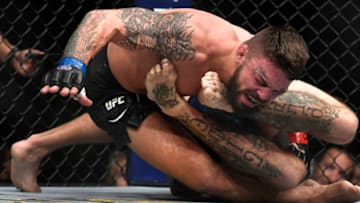 DENVER, CO - NOVEMBER 10: FS1 Main Card Donald Cerrone flips Mike Perry but keeps the armor and wins by submission in the first round of their welterweight 3 round bout during UFC Fight Night Main Card at the Pepsi Center on November 10, 2018 in Denver, Colorado. (Photo by Joe Amon/The Denver Post via Getty Images)