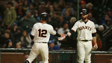 SAN FRANCISCO, CA - APRIL 30: Joe Panik #12 of the San Francisco Giants celebrates with Brandon Belt #9 after scoring on an RBI double hit by Buster Posey #28 in the bottom of the sixth inning against the Los Angeles Dodgers at Oracle Park on April 30, 2019 in San Francisco, California. (Photo by Lachlan Cunningham/Getty Images)