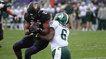 EVANSTON, IL - OCTOBER 28: Justin Jackson #21 of the Northwestern Wildcats is stopped short of the goal by David Dowell #6 of the Michigan State Spartans at Ryan Field on October 28, 2017 in Evanston, Illinois. (Photo by Jonathan Daniel/Getty Images)