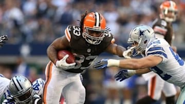 Nov 18, 2012; Arlington, TX, USA; Cleveland Browns running back Trent Richardson (33) runs with the ball in the fourth quarter against Dallas Cowboys linebacker Dan Connor (52) and safety Danny McCray (40) at Cowboys Stadium. The Cowboys beat the Browns 23-20 in overtime. Mandatory Credit: Matthew Emmons-USA TODAY Sports