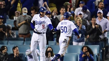 Oct 21, 2021; Los Angeles, California, USA; Los Angeles Dodgers right fielder Mookie Betts (50) celebrates with shortstop Corey Seager (5) after scoring in the eighth inning against the Atlanta Braves during game five of the 2021 NLCS at Dodger Stadium. Mandatory Credit: Gary A. Vasquez-USA TODAY Sports