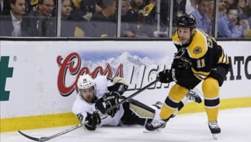 Jun 5, 2013; Boston, MA, USA; Pittsburgh Penguins center Brandon Sutter (16) and Boston Bruins center Gregory Campbell (11) battle for the puck during the first period in game three of the Eastern Conference finals of the 2013 Stanley Cup Playoffs at TD Garden. Mandatory Credit: Greg M. Cooper-USA TODAY Sports