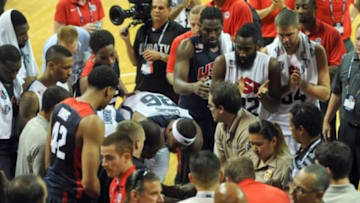 Aug 1, 2014; Las Vegas, NV, USA; USA Basketball players DeMarcus Cousins (36) and Kevin Durant (52) offer words of encouragement to guard Paul George as he is taken off the court on a gurney after suffering a leg injury during the USA Basketball Showcase at Thomas & Mack Center. Mandatory Credit: Stephen R. Sylvanie-USA TODAY Sports