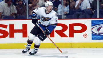 WASHINGTON - APRIL 15: Sergei Gonchar #55 of the Washington Capitals skates with the puck against the Tampa Bay Lightning in game three of the first round of the 2003 Eastern Conference Stanley Cup playoffs at the MCI Center on April 15, 2003 in Washington DC. The Lightning defeated the Capitals 4-3 in overtime. (Photo by Mitchell Layton/Getty Images/NHLI)