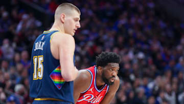 Nikola Jokic #15 of the Denver Nuggets looks on along with Joel Embiid #21 of the Philadelphia 76ers at the Wells Fargo Center on 14 Mar. 2022 in Philadelphia, Pennsylvania. The Nuggets defeated the 76ers 114-110. (Photo by Mitchell Leff/Getty Images)