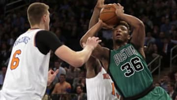 Feb 2, 2016; New York, NY, USA; Boston Celtics guard Marcus Smart (36) looks to shoot defended by New York Knicks forward Kristaps Porzingis (6) during the second half of an NBA basketball game at Madison Square Garden. The Celtics defeated the Knicks 97-89. Mandatory Credit: Adam Hunger-USA TODAY Sports