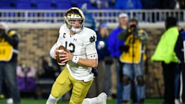 DURHAM, NORTH CAROLINA - NOVEMBER 09: Ian Book #12 of the Notre Dame Fighting Irish rolls out against the Duke Blue Devils during the first quarter of their game at Wallace Wade Stadium on November 09, 2019 in Durham, North Carolina. (Photo by Grant Halverson/Getty Images)