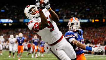 NEW ORLEANS, LA - JANUARY 02: DeVante Parker #9 of the Louisville Cardinals catches a second quarter touchdown pass over Loucheiz Purifoy #15 of the Florida Gators during the Allstate Sugar Bowl at Mercedes-Benz Superdome on January 2, 2013 in New Orleans, Louisiana. (Photo by Kevin C. Cox/Getty Images)