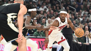 Apr 16, 2023; Milwaukee, Wisconsin, USA; Miami Heat forward Jimmy Butler (22) drives against Milwaukee Bucks guard Jrue Holiday (21) in the first half during game one of the 2023 NBA Playoffs at Fiserv Forum. Mandatory Credit: Michael McLoone-USA TODAY Sports