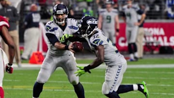 Jan 3, 2016; Glendale, AZ, USA; Seattle Seahawks quarterback Russell Wilson (3) hands off to running back Christine Michael (32) during the second half against the Arizona Cardinals at University of Phoenix Stadium. Mandatory Credit: Matt Kartozian-USA TODAY Sports
