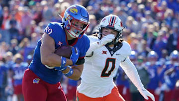 LAWRENCE, KS - NOVEMBER 05: Tight end Mason Fairchild #89 of the Kansas Jayhawks catch a pass against linebacker Mason Cobb #0 of the Oklahoma State Cowboys at David Booth Kansas Memorial Stadium on November 5, 2022 in Lawrence, Kansas. (Photo by Ed Zurga/Getty Images)