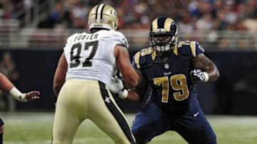 Aug 8, 2014; St. Louis, MO, USA; St. Louis Rams offensive tackle Greg Robinson (79) defends against New Orleans Saints defensive end Glenn Foster (97) during the first half at Edward Jones Dome. Mandatory Credit: Jeff Curry-USA TODAY Sports